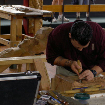 A carver producing maori art works